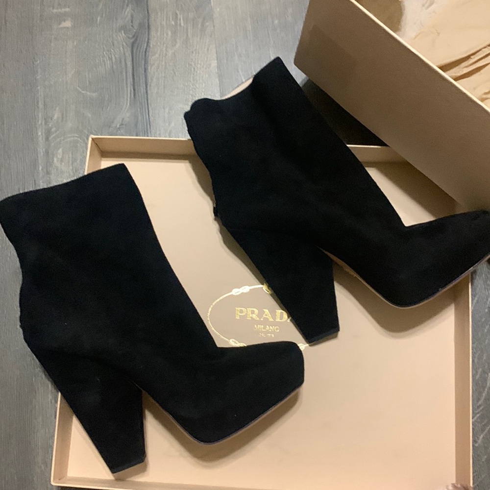 Black rear zip Prada booties.